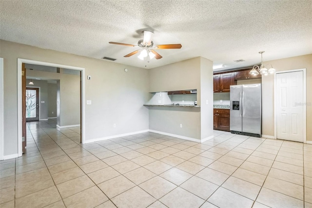 2002 Culpepper Dr, Brandon, FL 33511 - unfurnished living room featuring a ceiling fan, a chandelier, light tile patterned floors, and a textured ceiling