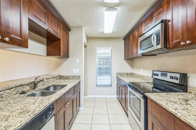 2002 Culpepper Dr, Brandon, FL 33511 - kitchen with stainless steel appliances, a textured ceiling, light stone countertops, and light tile patterned floors