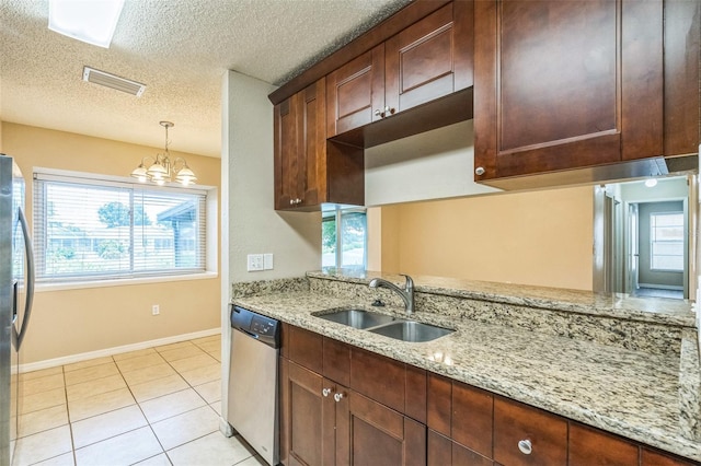 2002 Culpepper Dr, Brandon, FL 33511 - kitchen with appliances with stainless steel finishes, healthy amount of natural light, pendant lighting, light stone counters, and a textured ceiling
