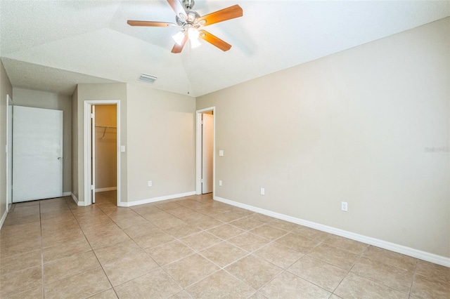 2002 Culpepper Dr, Brandon, FL 33511 - unfurnished bedroom with light tile patterned flooring, a spacious closet, a ceiling fan, a closet, and vaulted ceiling