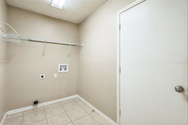 2002 Culpepper Dr, Brandon, FL 33511 - laundry room featuring washer hookup, hookup for an electric dryer, light tile patterned floors, and a textured ceiling