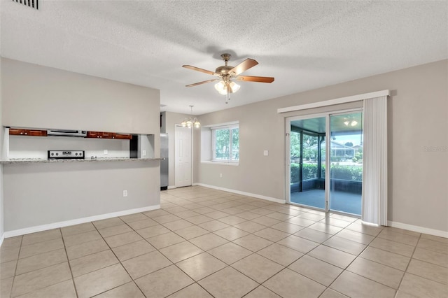 2002 Culpepper Dr, Brandon, FL 33511 - unfurnished living room featuring a ceiling fan, light tile patterned flooring, a textured ceiling, and a chandelier