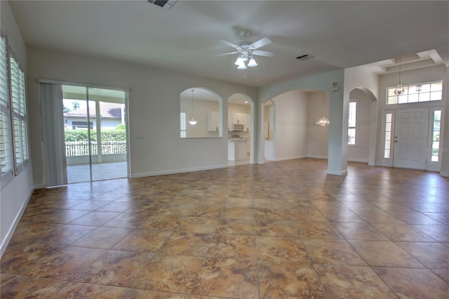 1679 Shadowmoss Cir, Lake Mary, FL 32746 - unfurnished living room with arched walkways, plenty of natural light, and a ceiling fan