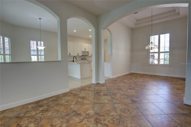 1679 Shadowmoss Cir, Lake Mary, FL 32746 - unfurnished room with a chandelier, recessed lighting, and a tray ceiling