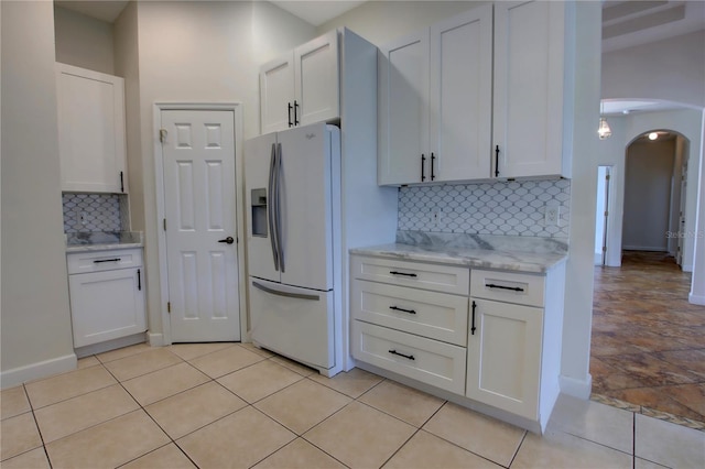 1679 Shadowmoss Cir, Lake Mary, FL 32746 - kitchen featuring white refrigerator with ice dispenser, arched walkways, and white cabinetry