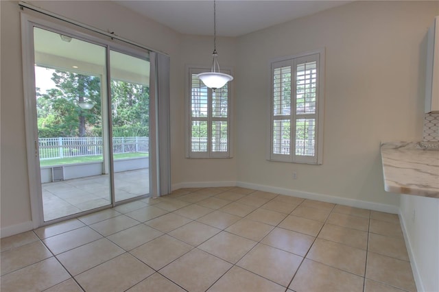 1679 Shadowmoss Cir, Lake Mary, FL 32746 - unfurnished dining area featuring light tile patterned flooring and baseboards
