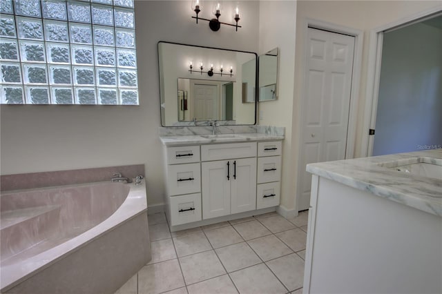 1679 Shadowmoss Cir, Lake Mary, FL 32746 - bathroom with two vanities, tile patterned floors, and a garden tub
