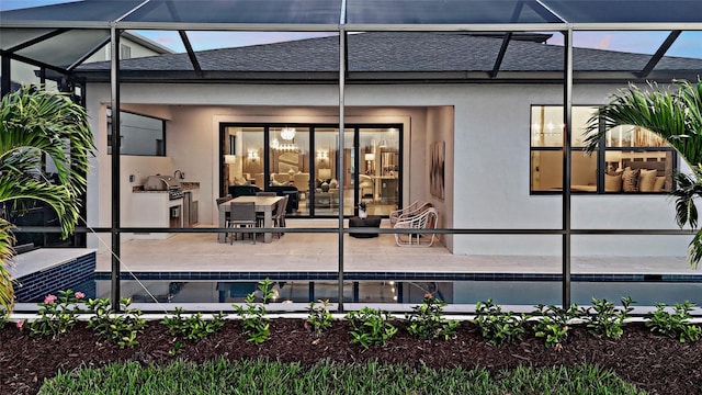 14375 Hammock Oak St, Parrish, FL 34219 - back of property with a lanai, a patio, roof with shingles, and stucco siding