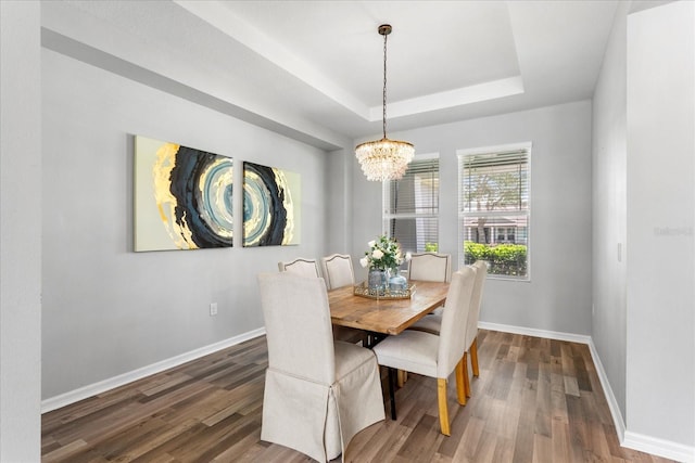 2781 Sand Oak Loop, Apopka, FL 32712 - dining space featuring a chandelier, a tray ceiling, and wood finished floors