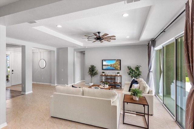 2781 Sand Oak Loop, Apopka, FL 32712 - living area featuring a tray ceiling, healthy amount of natural light, light tile patterned flooring, recessed lighting, and a ceiling fan