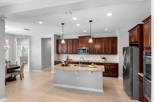 2781 Sand Oak Loop, Apopka, FL 32712 - kitchen with stainless steel appliances, backsplash, recessed lighting, hanging light fixtures, and light stone countertops