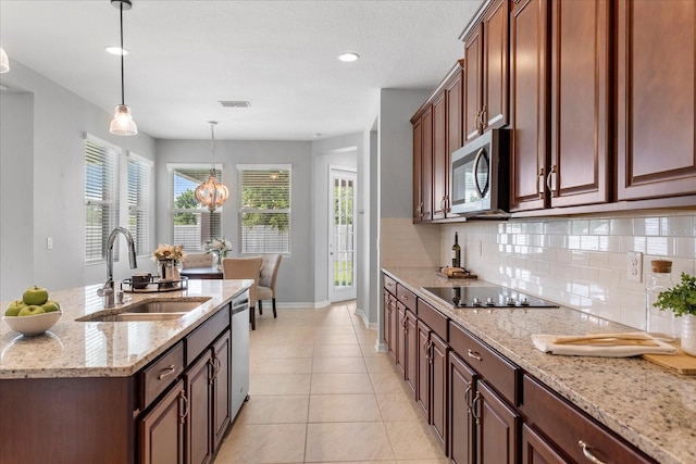 2781 Sand Oak Loop, Apopka, FL 32712 - kitchen featuring stainless steel appliances, tasteful backsplash, hanging light fixtures, light stone countertops, and light tile patterned flooring