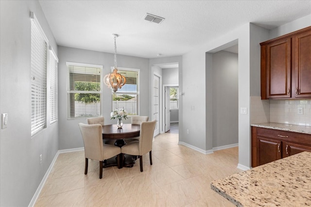 2781 Sand Oak Loop, Apopka, FL 32712 - dining space with light tile patterned floors and a chandelier