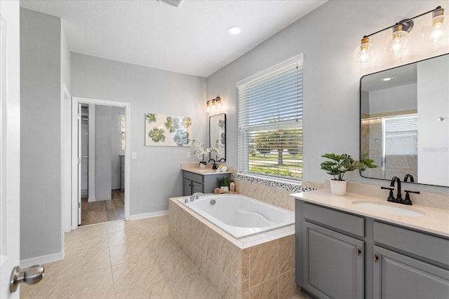 2781 Sand Oak Loop, Apopka, FL 32712 - full bathroom featuring two vanities, a bath, a tile shower, tile patterned flooring, and recessed lighting