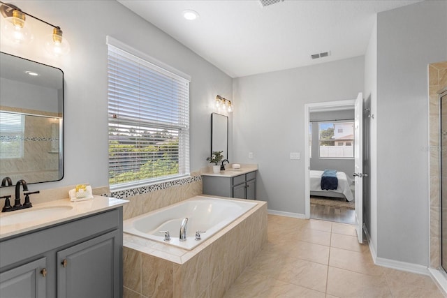 2781 Sand Oak Loop, Apopka, FL 32712 - bathroom with a stall shower, a garden tub, two vanities, ensuite bath, and tile patterned floors
