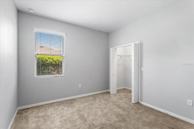 2781 Sand Oak Loop, Apopka, FL 32712 - unfurnished bedroom featuring light colored carpet and a closet