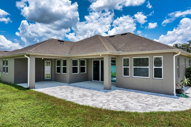 2781 Sand Oak Loop, Apopka, FL 32712 - back of property with stucco siding, a yard, a patio, and roof with shingles