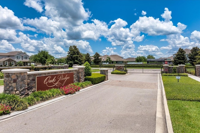 2781 Sand Oak Loop, Apopka, FL 32712 - view of asphalt street with a gate, curbs, and a residential view