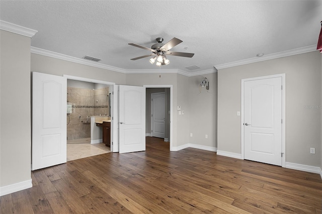 4244 Messina Dr, Lake Mary, FL 32746 - unfurnished bedroom featuring wood-type flooring, a textured ceiling, ensuite bath, ornamental molding, and a ceiling fan
