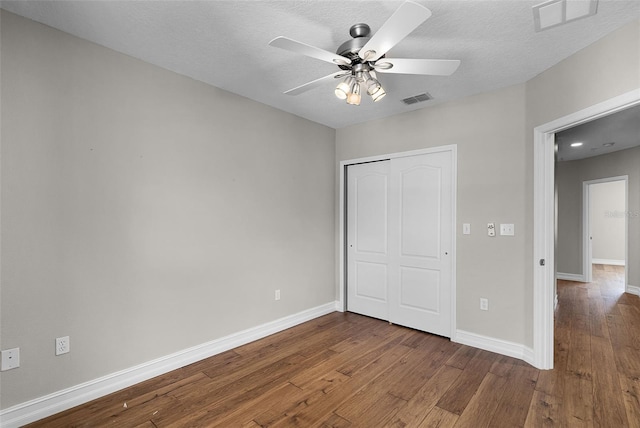 4244 Messina Dr, Lake Mary, FL 32746 - unfurnished bedroom with hardwood / wood-style flooring, a closet, a ceiling fan, and a textured ceiling