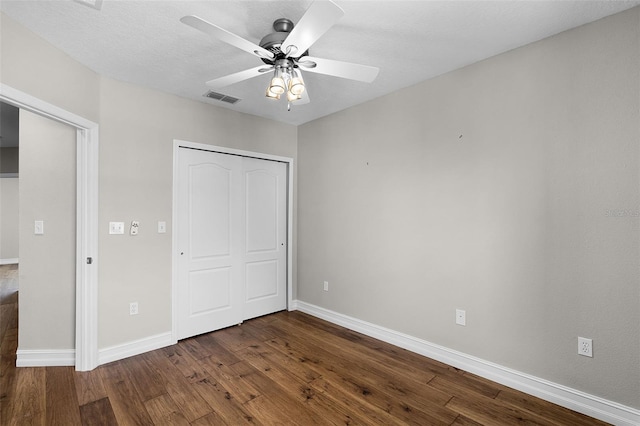 4244 Messina Dr, Lake Mary, FL 32746 - unfurnished bedroom with dark wood-style flooring, a closet, and a ceiling fan