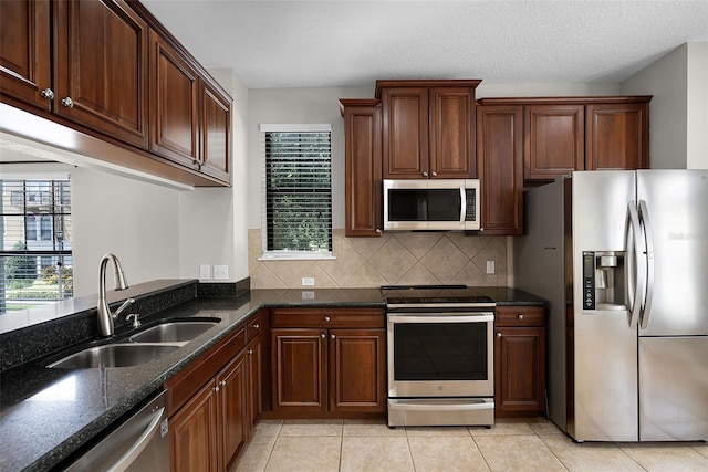4244 Messina Dr, Lake Mary, FL 32746 - kitchen featuring stainless steel appliances, backsplash, plenty of natural light, and dark stone countertops