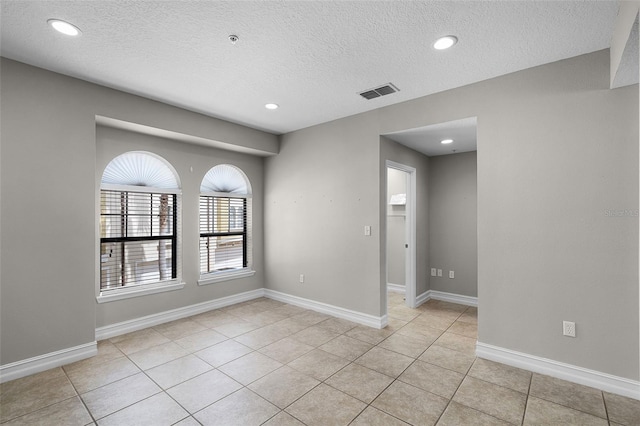 4244 Messina Dr, Lake Mary, FL 32746 - unfurnished room featuring a textured ceiling, recessed lighting, light tile patterned flooring, and fire sprinkler in ceiling