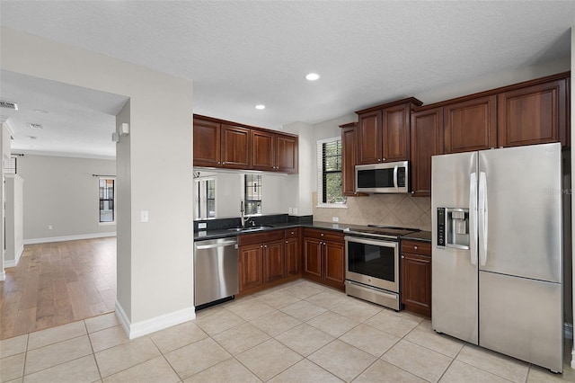 4244 Messina Dr, Lake Mary, FL 32746 - kitchen featuring stainless steel appliances, dark countertops, recessed lighting, decorative backsplash, and light tile patterned flooring