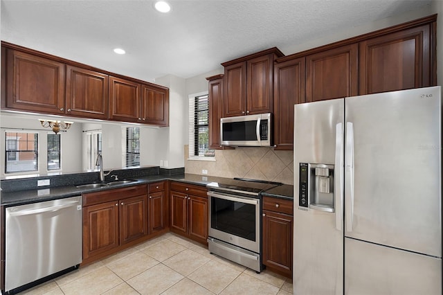 4244 Messina Dr, Lake Mary, FL 32746 - kitchen with stainless steel appliances, light tile patterned floors, recessed lighting, tasteful backsplash, and a chandelier