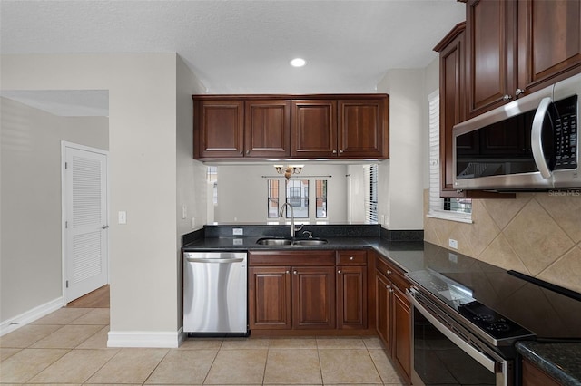 4244 Messina Dr, Lake Mary, FL 32746 - kitchen with stainless steel appliances, dark countertops, light tile patterned floors, decorative backsplash, and plenty of natural light