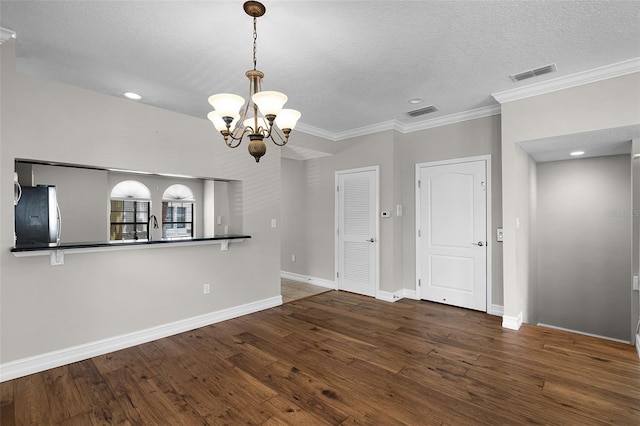4244 Messina Dr, Lake Mary, FL 32746 - spare room featuring a chandelier, a textured ceiling, wood finished floors, crown molding, and recessed lighting