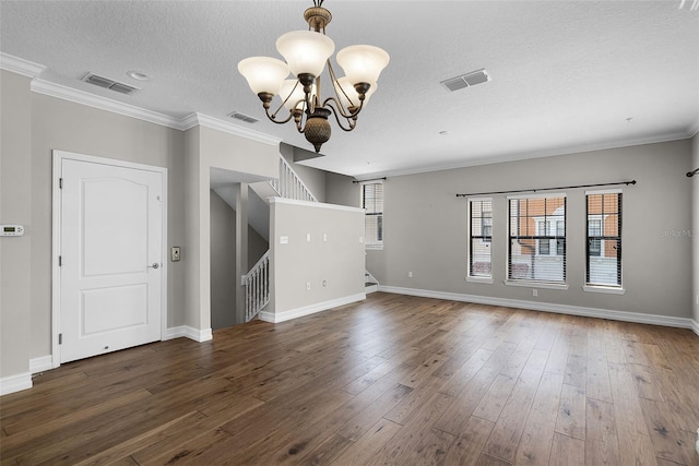 4244 Messina Dr, Lake Mary, FL 32746 - unfurnished living room featuring stairway, a chandelier, a textured ceiling, wood finished floors, and ornamental molding