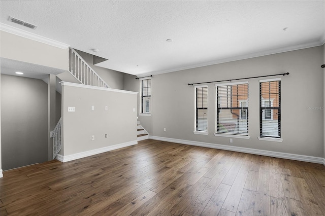 4244 Messina Dr, Lake Mary, FL 32746 - empty room featuring stairway, wood-type flooring, a textured ceiling, and ornamental molding