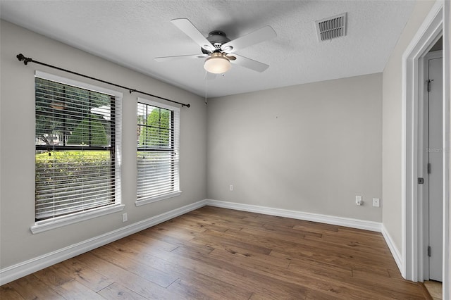 4244 Messina Dr, Lake Mary, FL 32746 - empty room with hardwood / wood-style flooring, a ceiling fan, and a textured ceiling