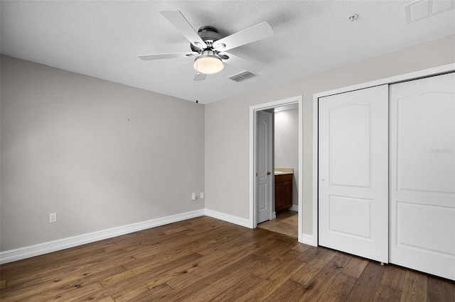 4244 Messina Dr, Lake Mary, FL 32746 - unfurnished bedroom with dark wood finished floors, a closet, connected bathroom, a textured ceiling, and ceiling fan