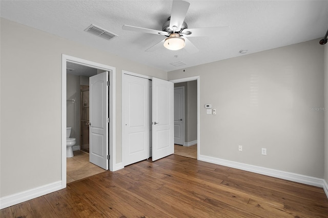 4244 Messina Dr, Lake Mary, FL 32746 - unfurnished bedroom with wood finished floors, a closet, ensuite bath, and a ceiling fan
