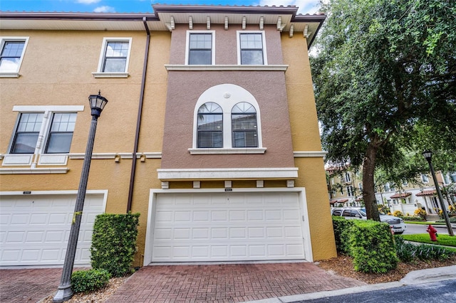 4244 Messina Dr, Lake Mary, FL 32746 - townhome / multi-family property featuring stucco siding, decorative driveway, and an attached garage