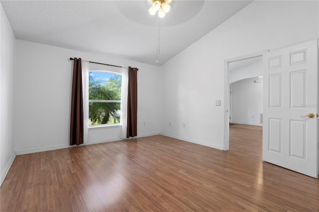 144 Fort Smith Blvd, Deltona, FL 32738 - unfurnished room featuring ceiling fan, wood finished floors, vaulted ceiling, and arched walkways