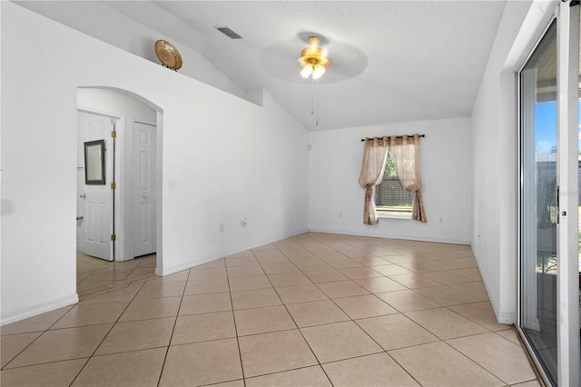 144 Fort Smith Blvd, Deltona, FL 32738 - spare room with vaulted ceiling, ceiling fan, plenty of natural light, and light tile patterned flooring