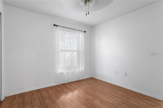 144 Fort Smith Blvd, Deltona, FL 32738 - empty room with wood finished floors, a ceiling fan, and a textured ceiling