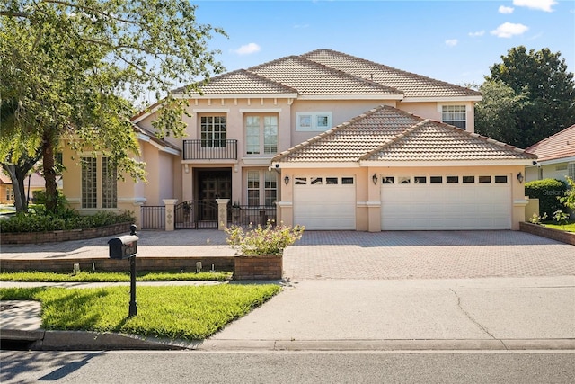 9128 Phillips Grove Ter, Orlando, FL 32836 - mediterranean / spanish home featuring stucco siding, a garage, driveway, a balcony, and a tile roof