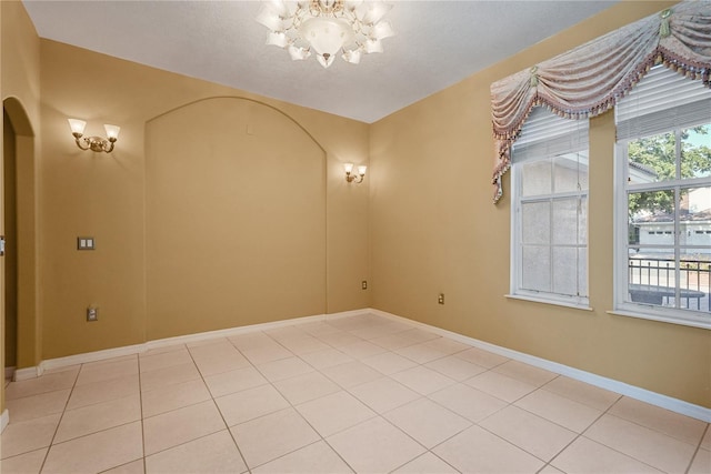 9128 Phillips Grove Ter, Orlando, FL 32836 - unfurnished room with a chandelier, light tile patterned flooring, and arched walkways