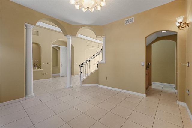 9128 Phillips Grove Ter, Orlando, FL 32836 - spare room featuring light tile patterned flooring, a chandelier, stairs, and arched walkways
