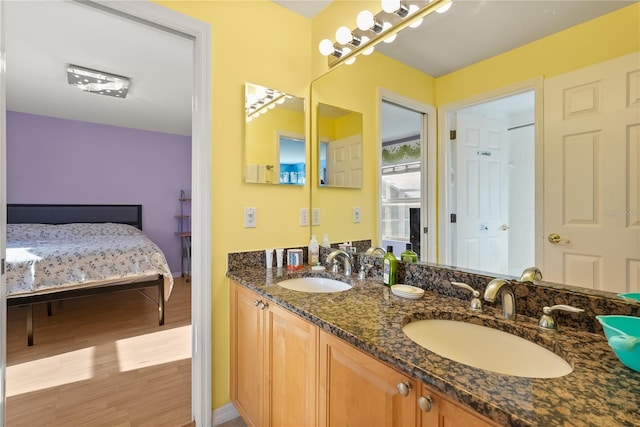 9128 Phillips Grove Ter, Orlando, FL 32836 - ensuite bathroom featuring wood finished floors and double vanity