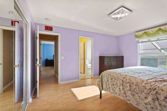 9128 Phillips Grove Ter, Orlando, FL 32836 - bedroom featuring light wood-style floors and ensuite bath