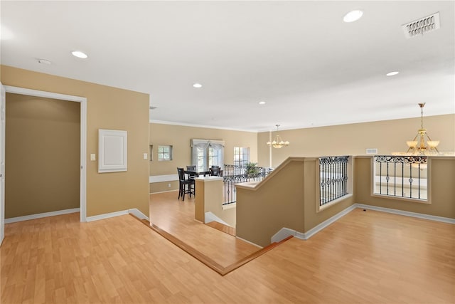 9128 Phillips Grove Ter, Orlando, FL 32836 - hallway featuring a chandelier, light wood-type flooring, an upstairs landing, recessed lighting, and crown molding