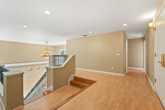 9128 Phillips Grove Ter, Orlando, FL 32836 - hallway featuring an upstairs landing, a chandelier, light wood-style flooring, and recessed lighting