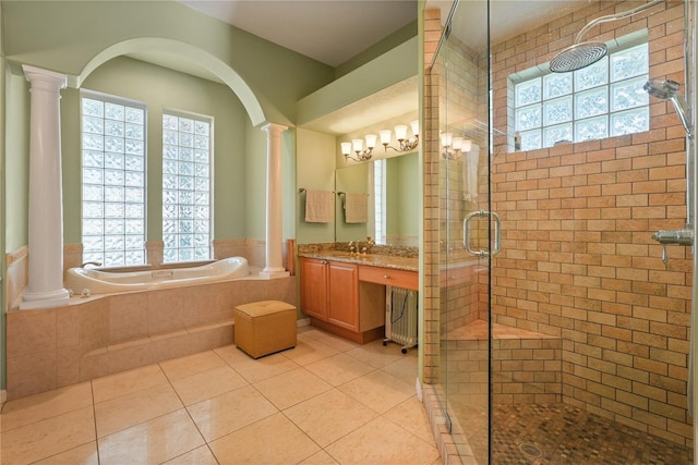 9128 Phillips Grove Ter, Orlando, FL 32836 - full bath featuring ornate columns, a bath, a shower stall, and vanity