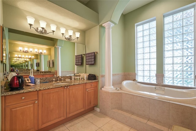 9128 Phillips Grove Ter, Orlando, FL 32836 - full bath with ornate columns, a bath, vanity, and tile patterned floors