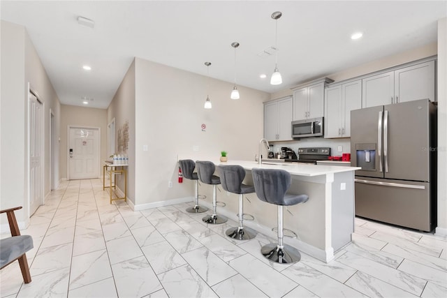 4974 Windermere Ave, Kissimmee, FL 34746 - kitchen with stainless steel appliances, light marble finish flooring, gray cabinetry, a breakfast bar area, and recessed lighting